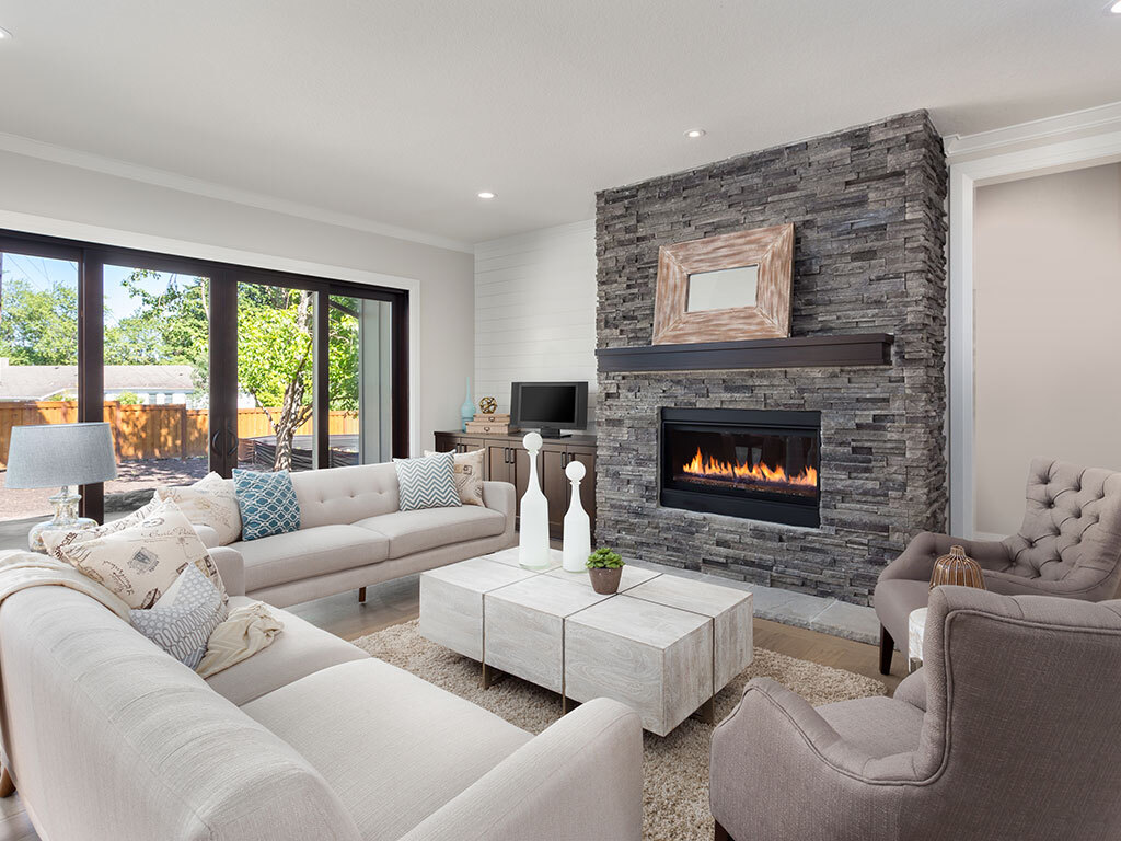 Transitional family room with modern furnishings and grey stone fireplace